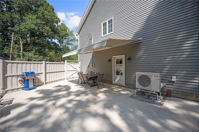 view of patio / terrace with a grill and ac unit