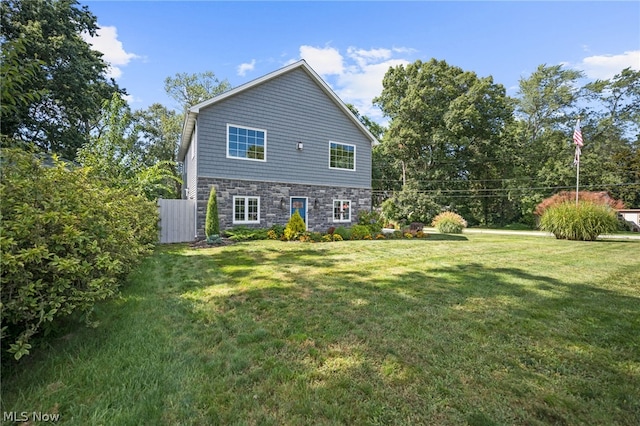 back of house with a lawn