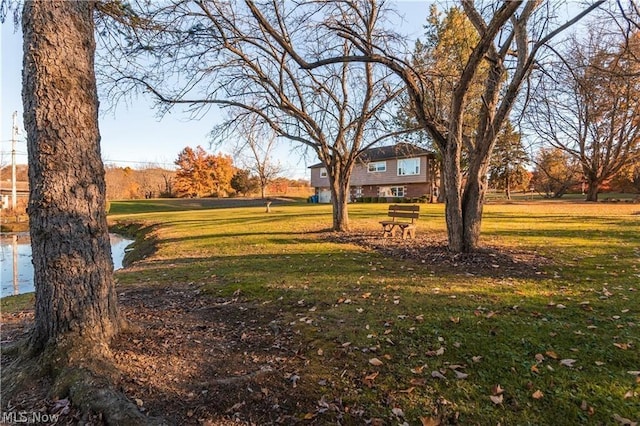 surrounding community featuring a yard and a water view