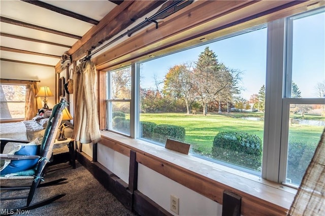 sunroom featuring beamed ceiling