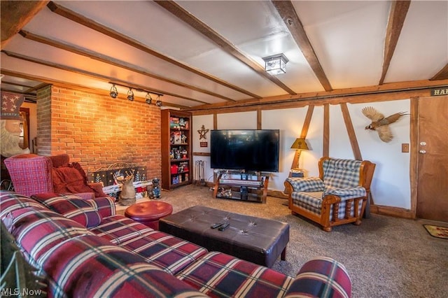 living room featuring carpet flooring, a fireplace, rail lighting, and beamed ceiling