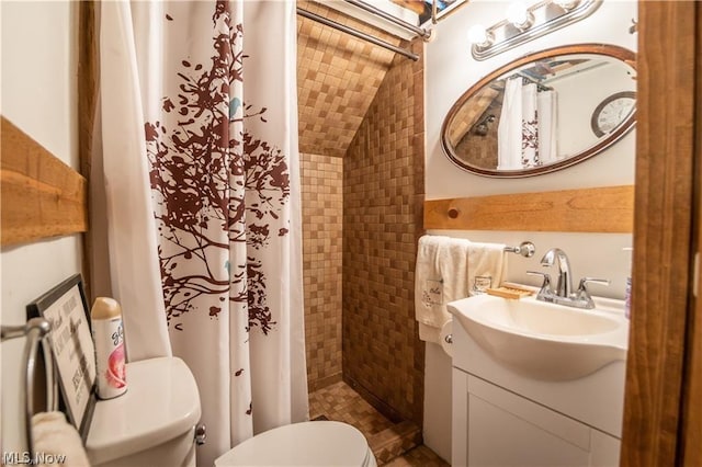 bathroom featuring vanity, a shower with shower curtain, lofted ceiling, and toilet