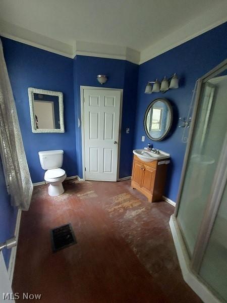 bathroom with vanity, crown molding, and toilet