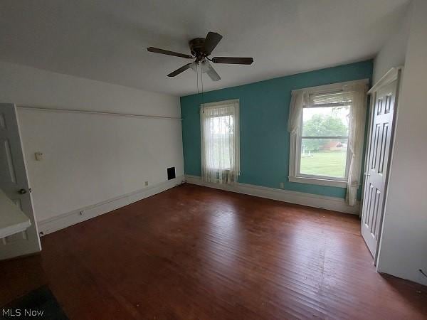 interior space featuring dark wood-type flooring and ceiling fan