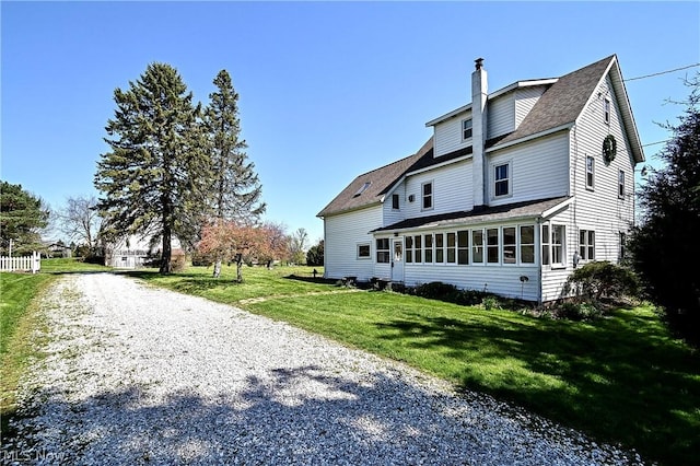 exterior space with a lawn and a sunroom