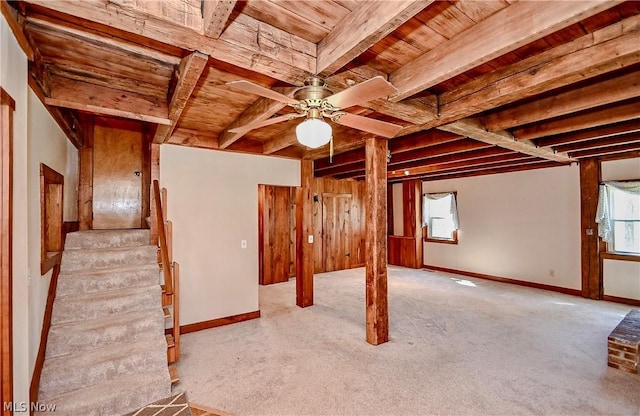 basement featuring light colored carpet, ceiling fan, and wood ceiling