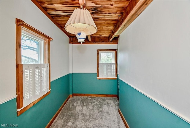 unfurnished room featuring light carpet, a healthy amount of sunlight, and wooden ceiling