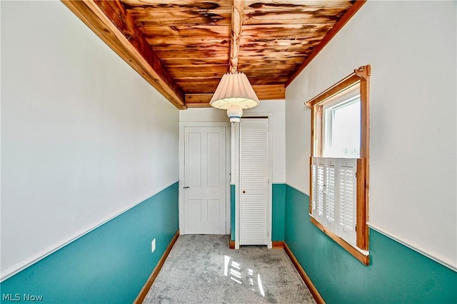 interior space with carpet floors and wooden ceiling