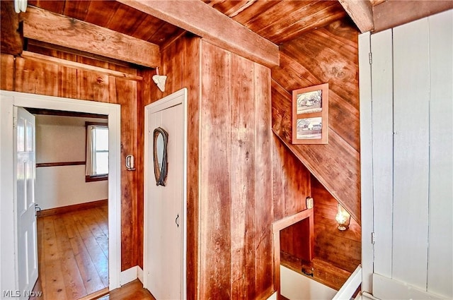 staircase featuring wood walls and wooden ceiling