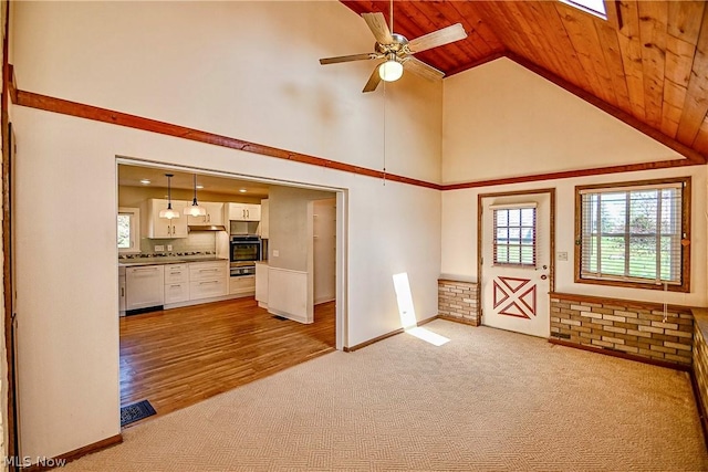 unfurnished living room featuring light carpet, lofted ceiling, ceiling fan, and wooden ceiling