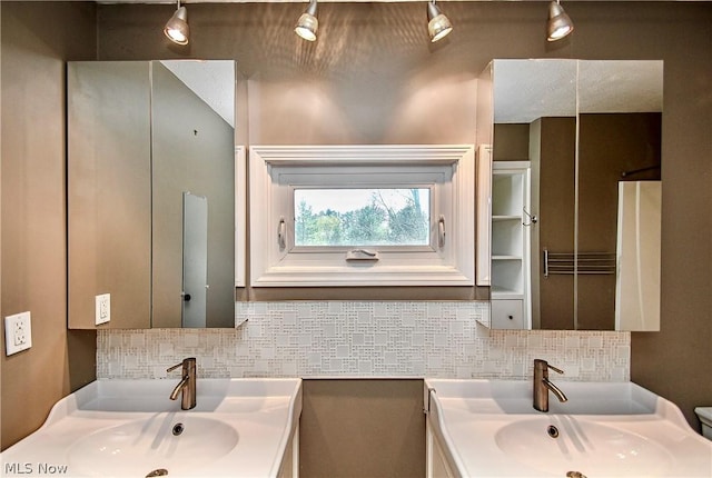 bathroom featuring tasteful backsplash and vanity