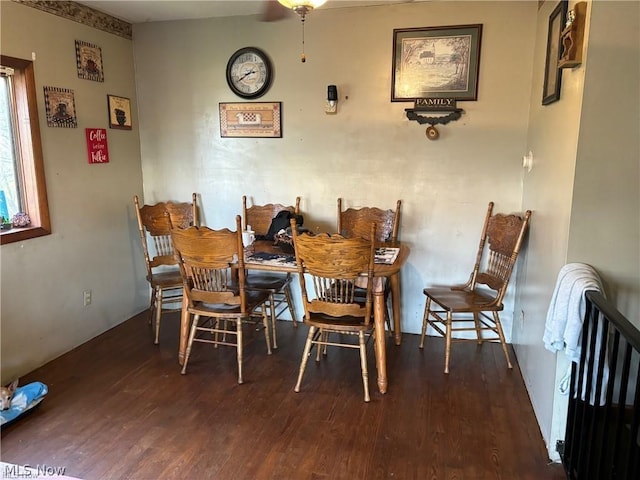 dining space with dark hardwood / wood-style flooring