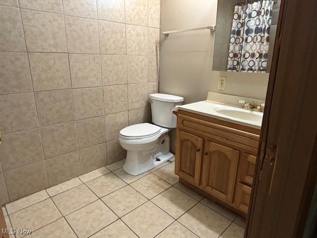 bathroom with tile patterned floors, vanity, and toilet