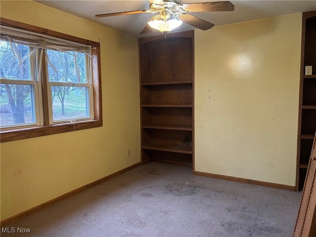 spare room with ceiling fan and light carpet