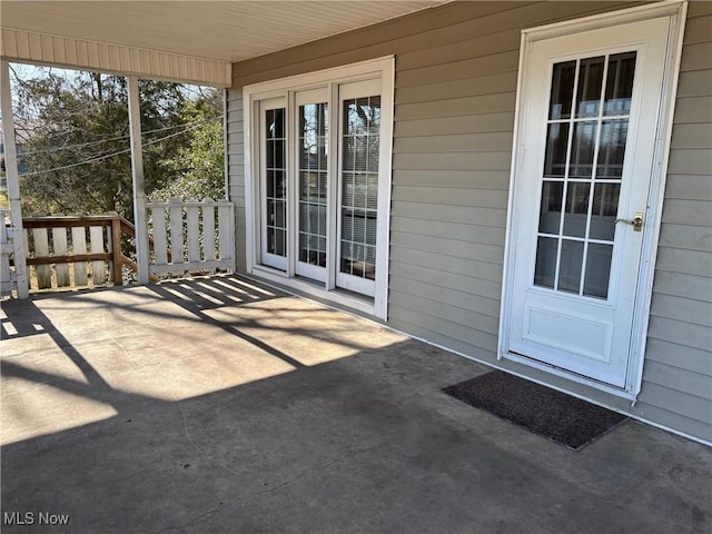 entrance to property featuring a patio