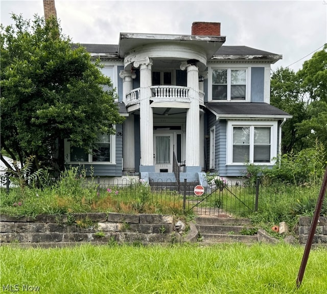 greek revival house with covered porch and a balcony