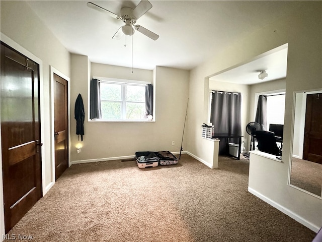 interior space with multiple closets, carpet, and ceiling fan