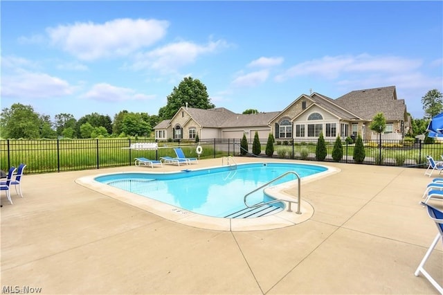 view of swimming pool with a patio area