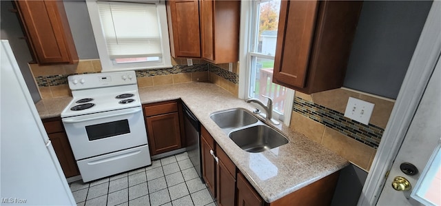 kitchen featuring white appliances, sink, decorative backsplash, light stone countertops, and light tile patterned flooring