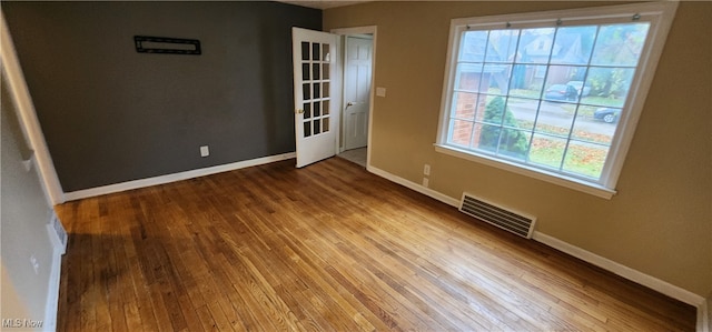 unfurnished room featuring hardwood / wood-style floors