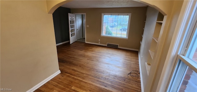 empty room with hardwood / wood-style flooring