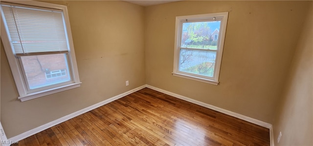 spare room with hardwood / wood-style floors