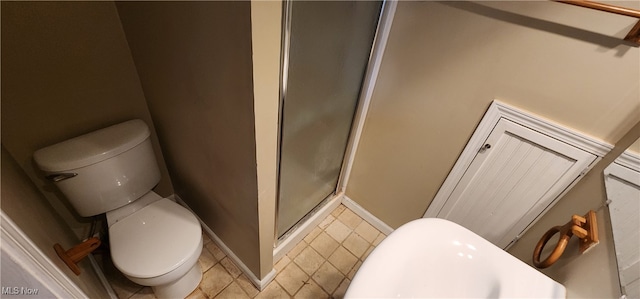 bathroom featuring toilet and an enclosed shower