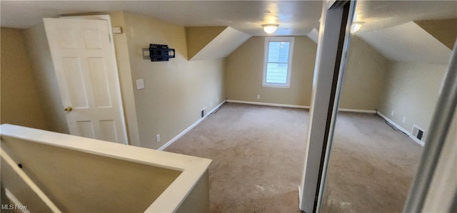 additional living space featuring lofted ceiling and carpet floors