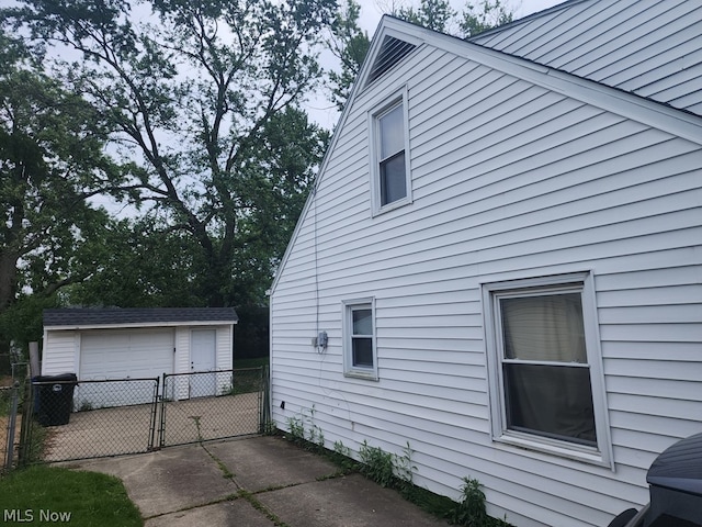 view of property exterior featuring an outdoor structure and a garage