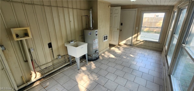 utility room featuring water heater