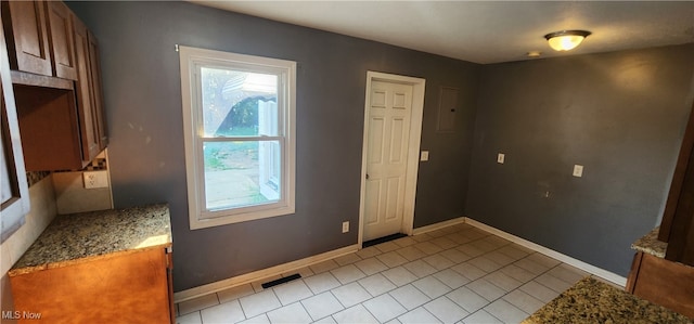 entryway with light tile patterned floors