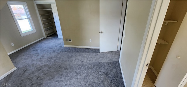 unfurnished bedroom featuring carpet floors and a closet