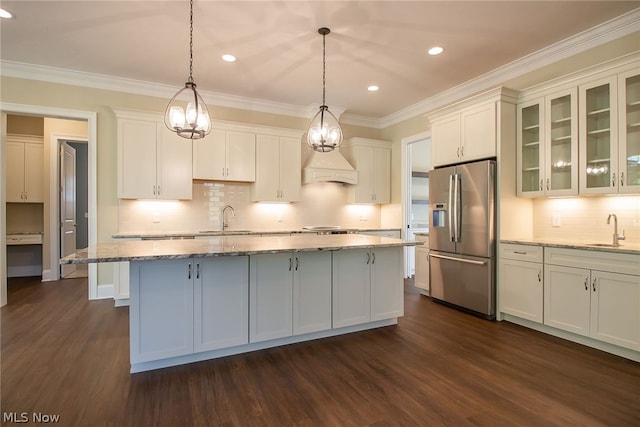 kitchen featuring dark hardwood / wood-style floors, tasteful backsplash, and stainless steel fridge with ice dispenser