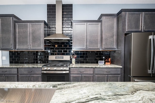 kitchen with tasteful backsplash, dark brown cabinetry, light stone countertops, and stainless steel appliances