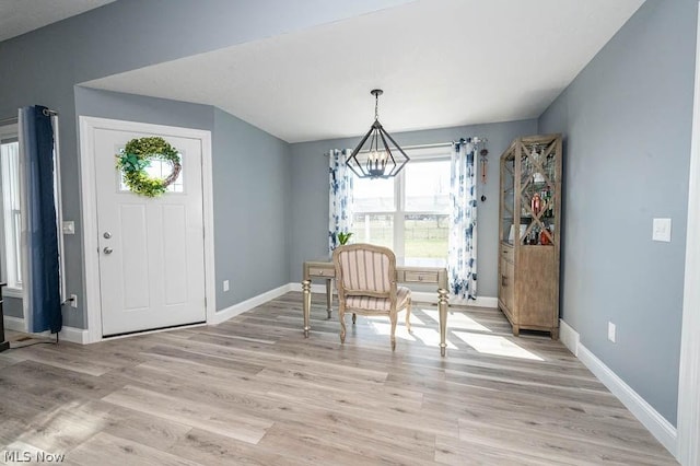 dining area featuring light hardwood / wood-style flooring and an inviting chandelier