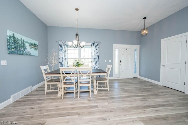 unfurnished dining area with light hardwood / wood-style flooring and a notable chandelier