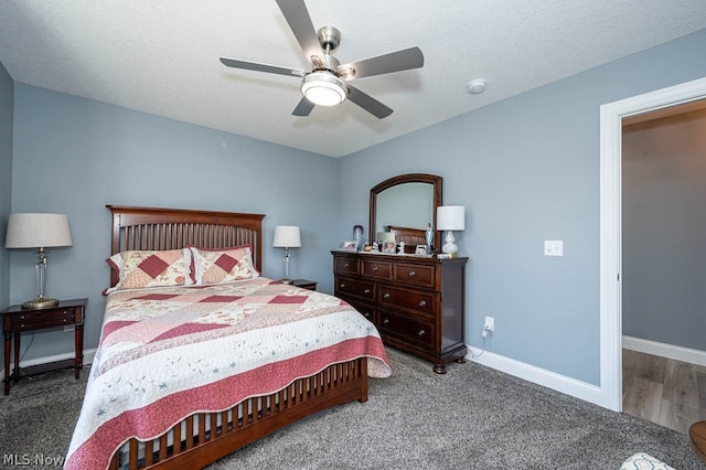 bedroom with a textured ceiling, dark hardwood / wood-style floors, and ceiling fan