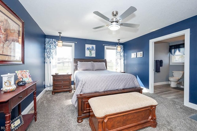 bedroom with carpet, ceiling fan, and ensuite bath