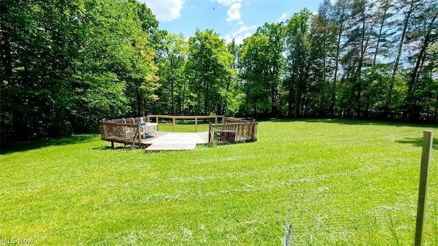 view of property's community with a yard and a deck