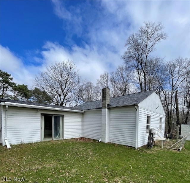 back of property featuring a lawn