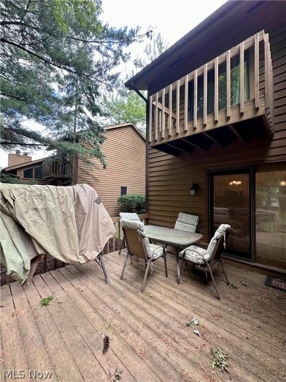 wooden deck featuring outdoor dining area