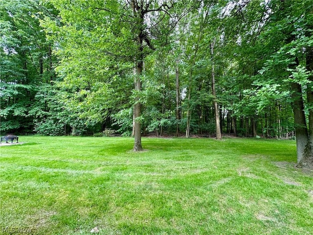 view of yard with a forest view