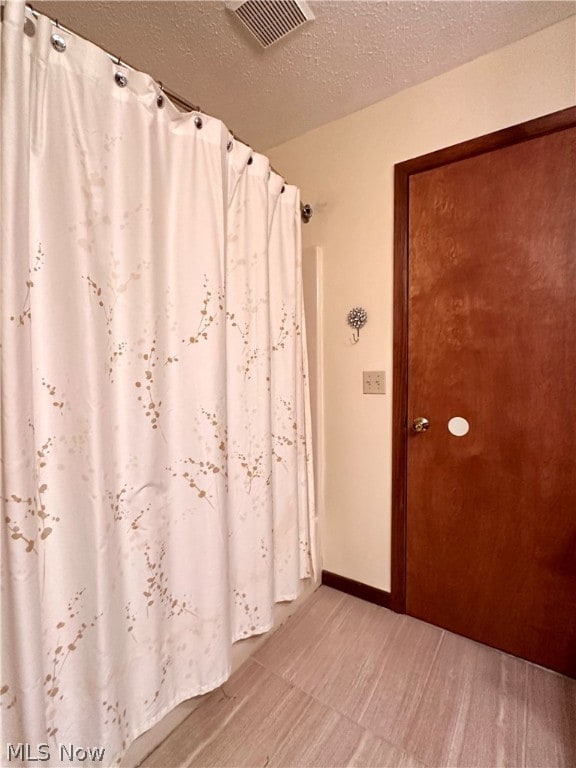 bathroom with a textured ceiling