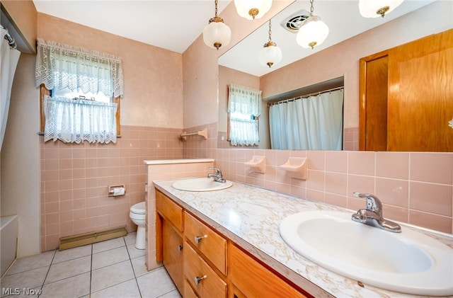 bathroom featuring a shower with curtain, vanity, tile walls, tile patterned flooring, and toilet