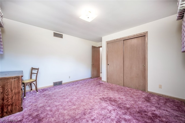 carpeted bedroom with a closet