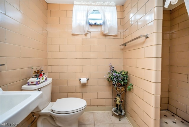 bathroom featuring sink, tile patterned flooring, and toilet