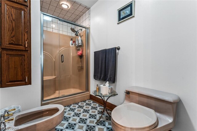 bathroom featuring walk in shower, tile floors, a bidet, sink, and toilet