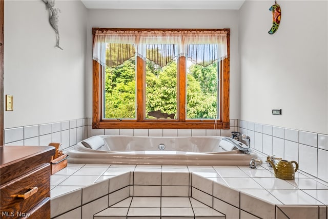 bathroom featuring plenty of natural light and tiled tub