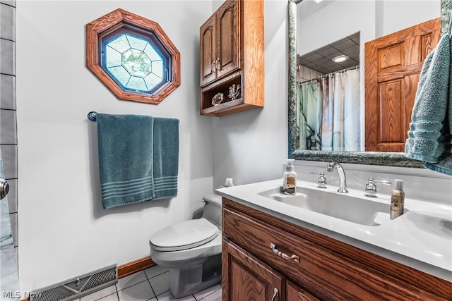 bathroom featuring tile floors, toilet, and vanity