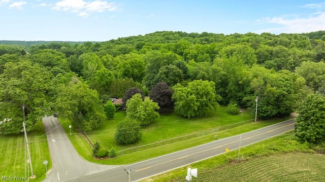 birds eye view of property featuring a view of trees